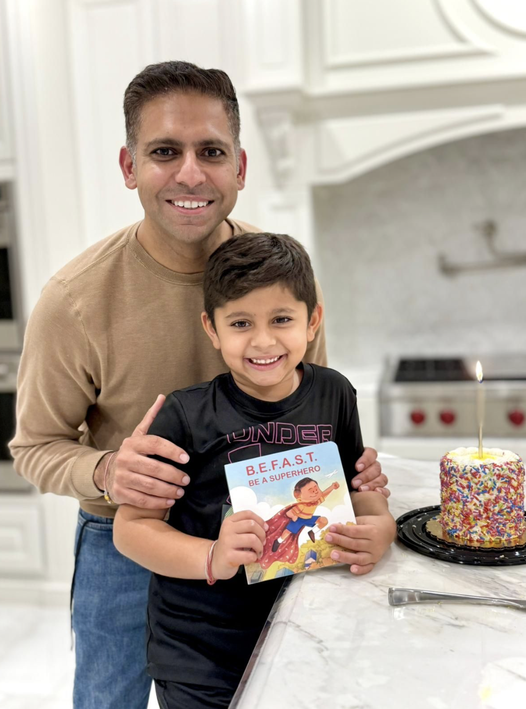 Dr. Rajiv Narula and Ayan with the BeASuperhero book